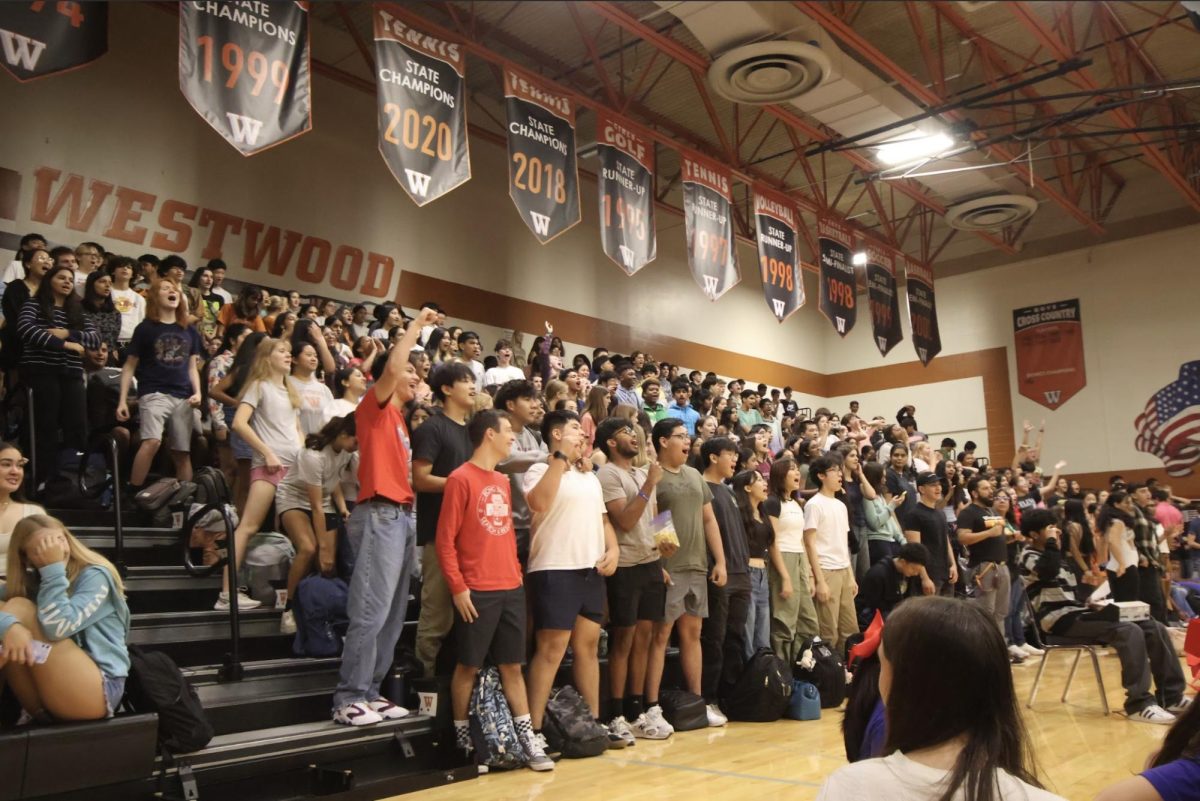 Cheering eagerly in hopes of receiving a free pizza, students crowd the bleachers for the second pep rally of the year. For many, the pep rally served to be a fun break from the ramping rigor of academics. 